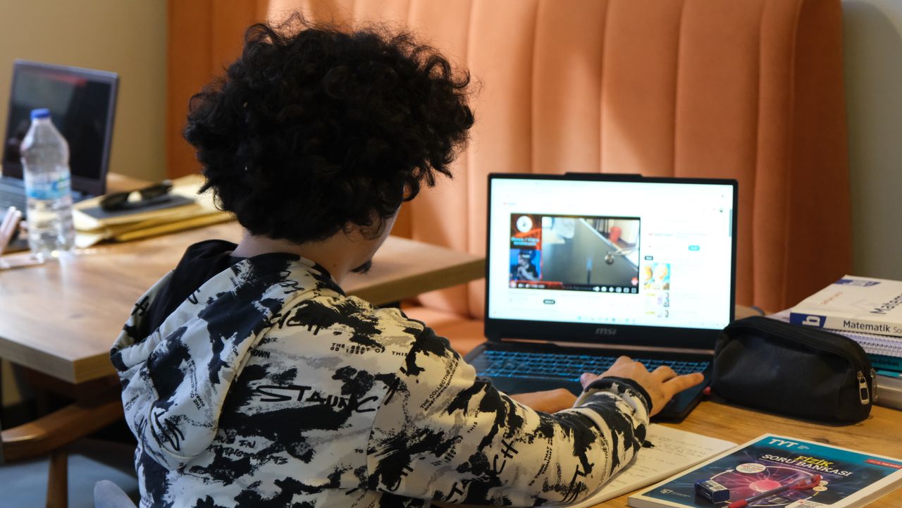 A student having an online lesson on a laptop at home